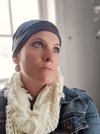 Low angle view of thoughtful woman looking away while sitting at home