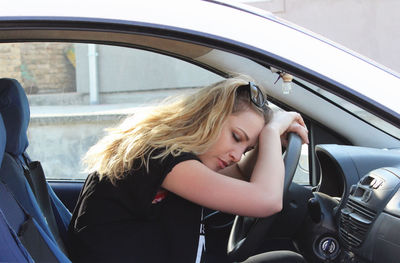 Portrait of woman sitting in car