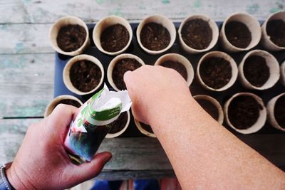 Cropped hand planting seeds