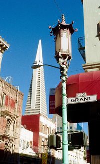 Low angle view of street light against blue sky