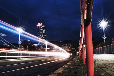 Light trails on bridge in city at night