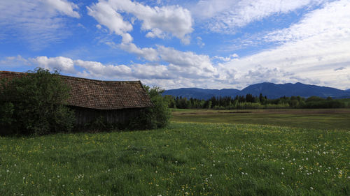 Built structure on field against sky