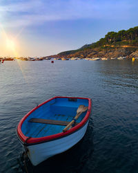 Boat moored on sea against sky