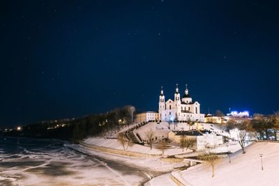 Illuminated cathedral against sky in city at night