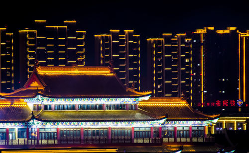 Illuminated buildings in city at night