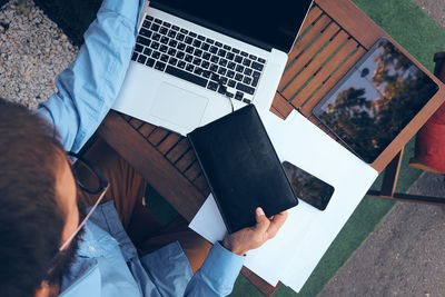 High angle view of man using laptop on table