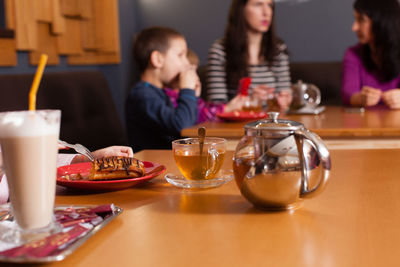 High angle view of people sitting on table