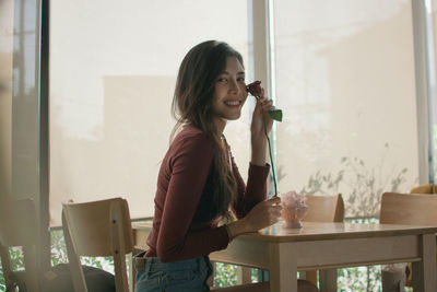 Young woman drinking glasses on table