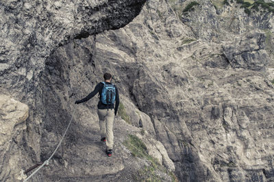 Rear view full length of male hiker hiking at ellmauer halt