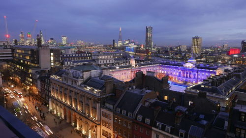 High angle view of buildings in city at night