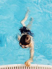 High angle view of boy swimming in pool