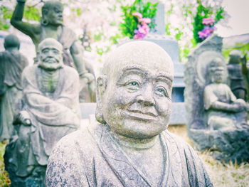 Close-up of statue against stone wall