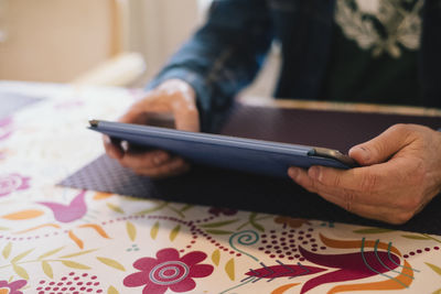 Midsection of man using mobile phone