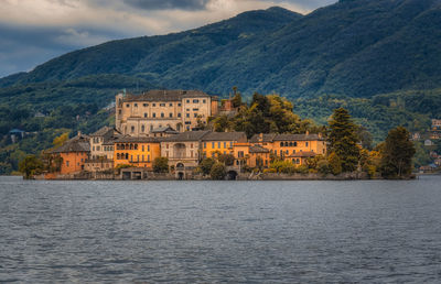 Building by mountains against sky