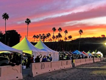 Group of people at beach during sunset