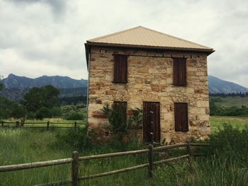 Built structure on field against sky