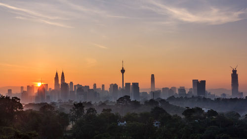 View of buildings in city during sunset