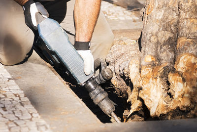 Low section of man working on wood