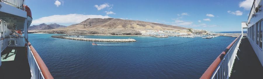 Panoramic view of sea and mountains against sky