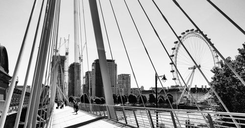 Bridge in city against clear sky