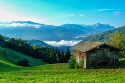 Scenic view of village and mountains against sky