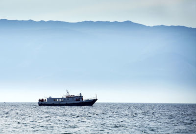 Boat sailing in sea against sky