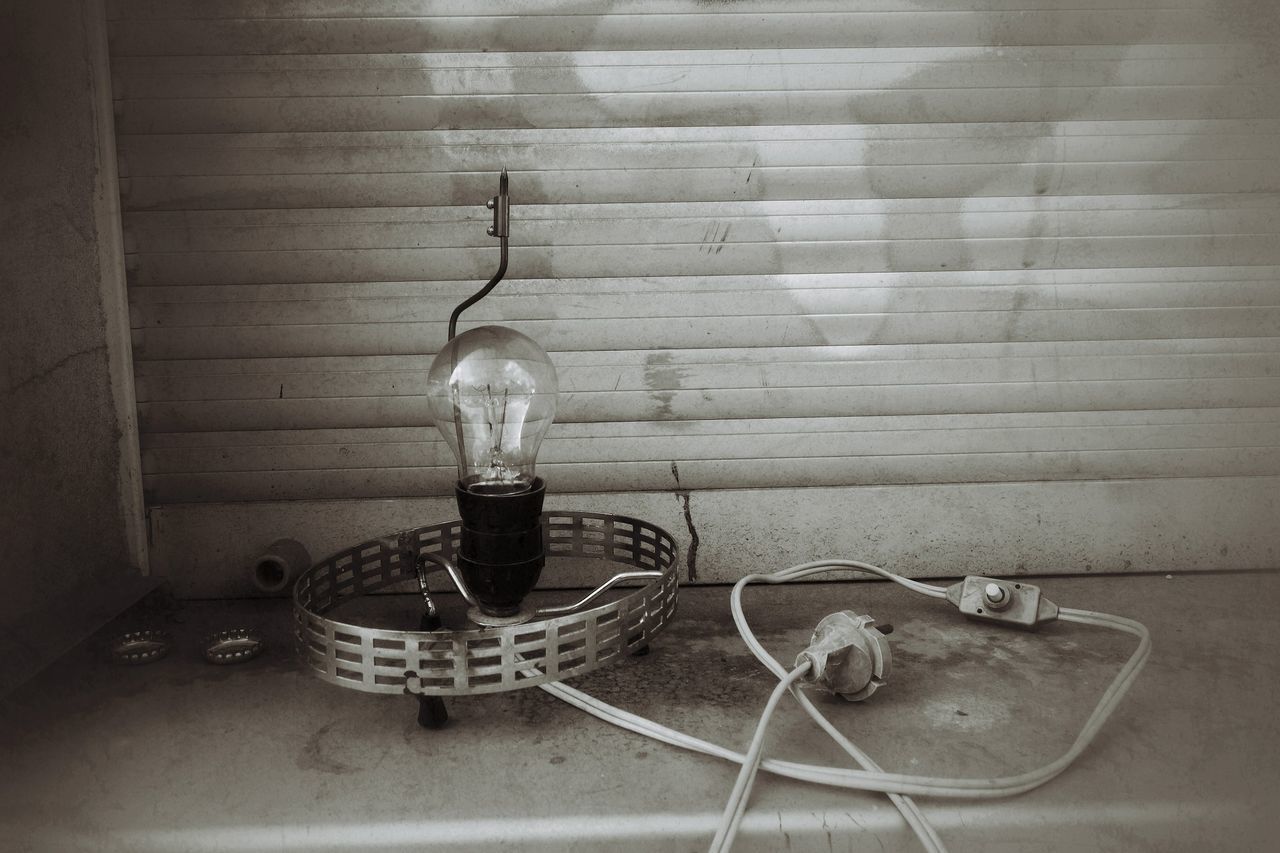 indoors, table, wall - building feature, still life, home interior, chair, high angle view, absence, no people, domestic room, metal, wall, empty, close-up, domestic kitchen, wood - material, lighting equipment, day, shadow, glass - material