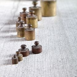 Close-up of various weights on wooden table