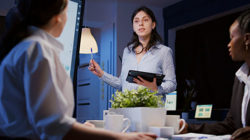 Young woman using mobile phone in office