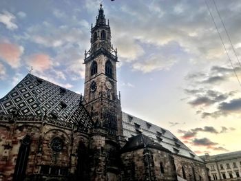 Low angle view of church against cloudy sky