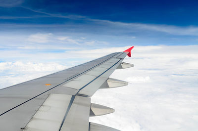 Close-up of airplane wing against sky