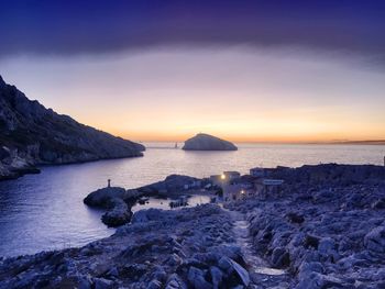 Scenic view of sea against clear sky at sunset