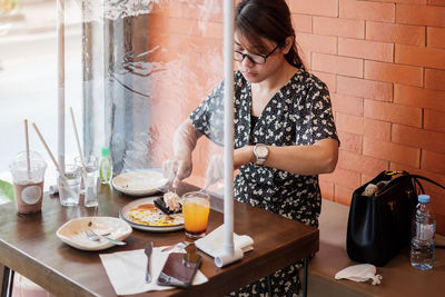 Young woman looking away at table