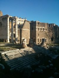 Buildings against clear blue sky