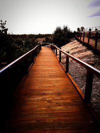 Footbridge against clear sky