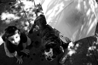 Portrait of boy with dog outdoors