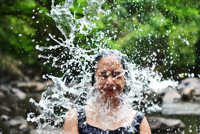 Portrait of a man splashing water