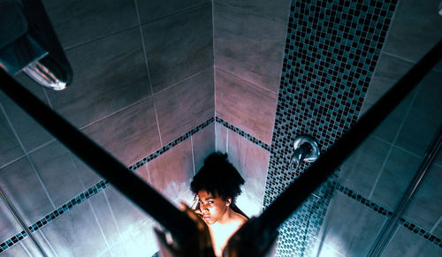 High angle view of teenage boy in bathroom