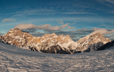 Majestic winter panorama of cadore region dolomite peaks at sunset