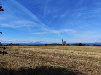 Scenic view of field and castle against sky