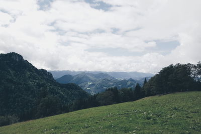 Scenic view of mountains against cloudy sky