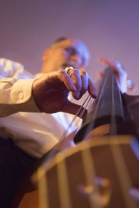 Close-up of man playing guitar