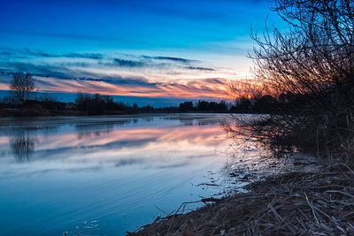 Scenic view of lake at sunset