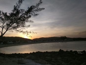 Scenic view of lake against sky at sunset