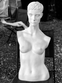 Statue of man and woman sitting on seat