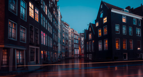 Buildings against sky at night