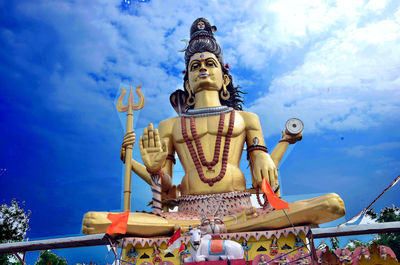 Low angle view of statue against blue sky