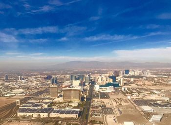 Aerial view of cityscape against blue sky