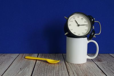 Close-up of clock on table