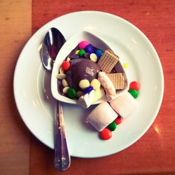 High angle view of candies in plate on table